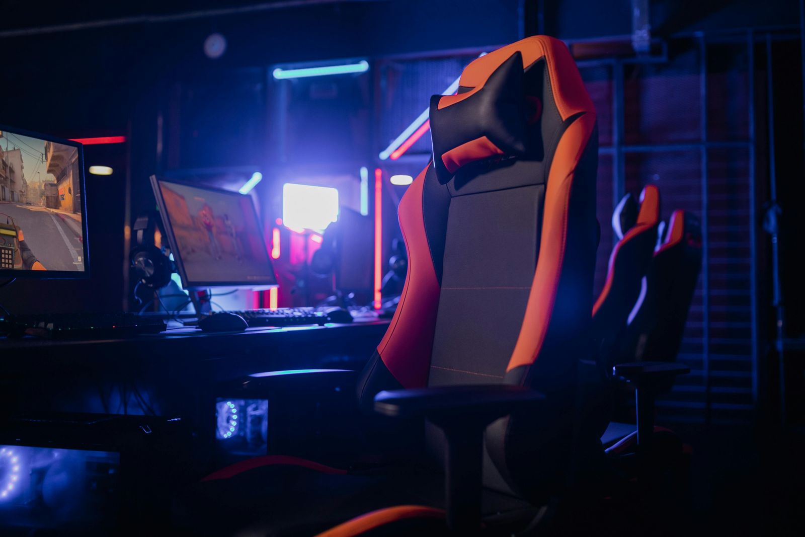 Gaming chair and competition PC in a dark esports room